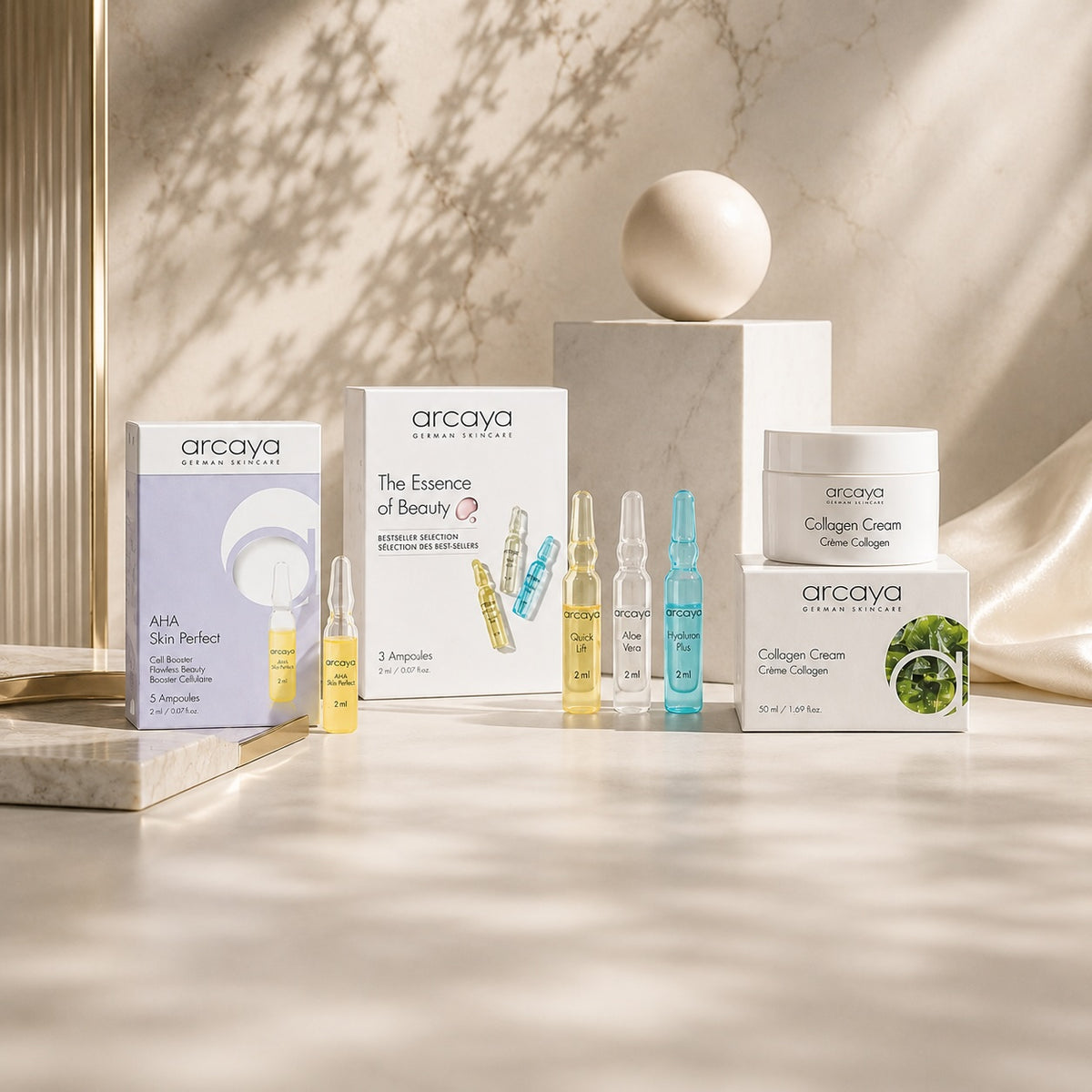 arcaya Produkte mit AHA Skin Perfect, The Essence of Beauty und Collagen Cream auf hellem Stein