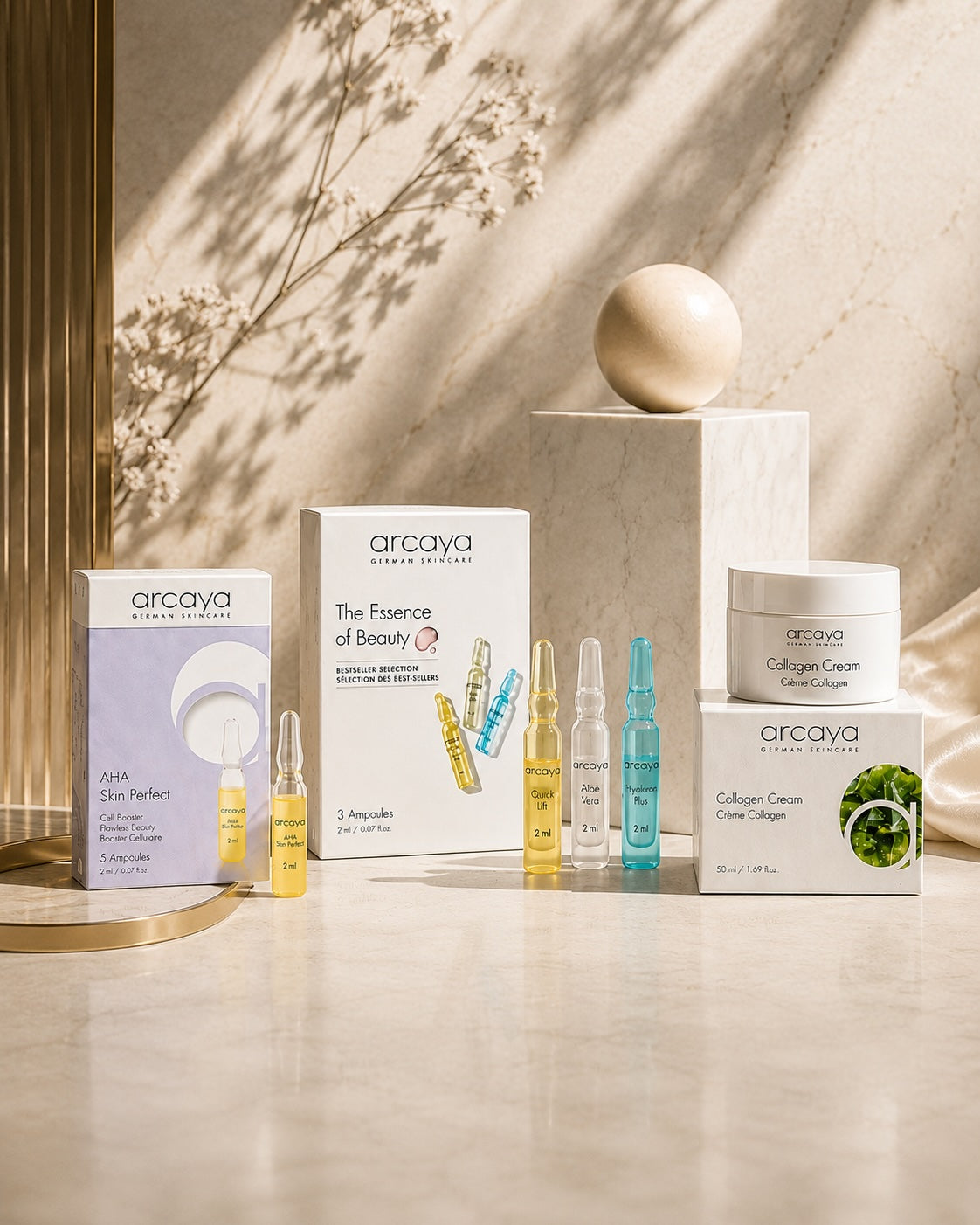 arcaya Produkte mit AHA Skin Perfect, The Essence of Beauty und Collagen Cream auf hellem Stein